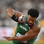 Nigerian hammer thrower in a green jersey preparing to throw the hammer in a stadium  trybalnews