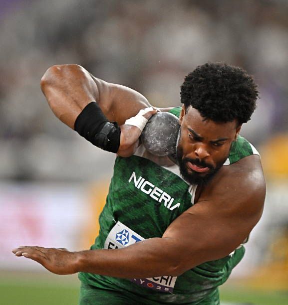 Nigerian hammer thrower in a green jersey preparing to throw the hammer in a stadium  trybalnews