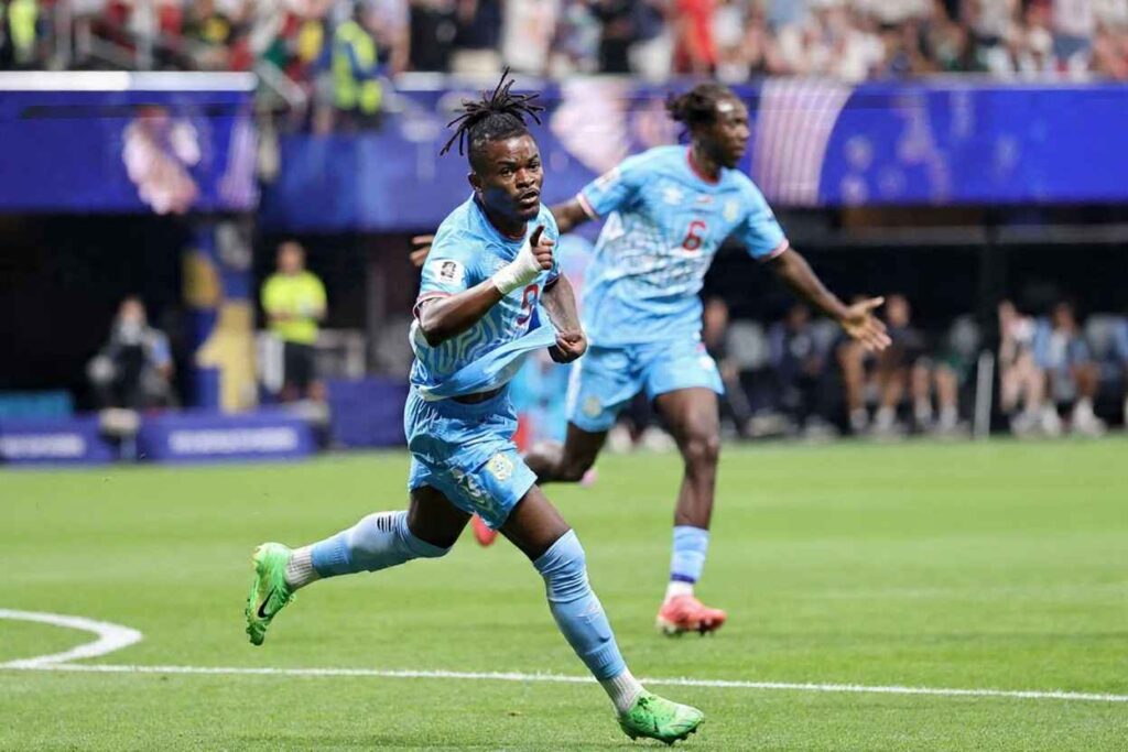 DR Congo forward Brian Cipenga wearing the 9 light blue kit with a white wrist bandage celebrates after scoring his teamaposs first goal with a teammate running behind him during the FIFA World Cup 2026 Round of 32 match against England at Atlanta Stadium in Atlanta Georgia on July 1 2026  trybalnews