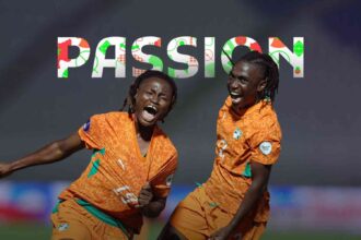 Two soccer players in orange uniforms celebrate on the field as 'PASSION' appears in colorful letters above them on the graphic background.
