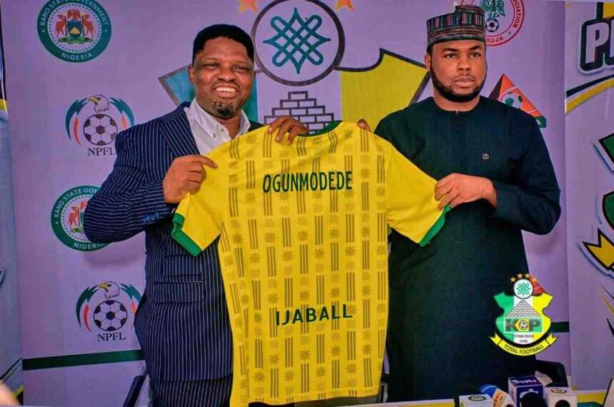 New Kano Pillars Technical Adviser Daniel Ogunmodede and Kano Pillars Chairman Alhaji Ahmad Musbahu Garo holding up a yellow and green Kano Pillars jersey with OGUNMODEDE and IJABALL on the back during his official press unveiling Photo Credit Kano Pillars Media  trybalnews