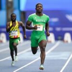 Nigerian sprinter Favour Oghene Tejiri Ashe runs on the track in a green Nigeria kit during the mens 100m heats He is in the lead with another athlete in yellow and green behind him The race takes place at Scotstoun Stadium during the Glasgow 2026 Commonwealth Games Photo by Rob CaseySNS Group via Getty Images  trybalnews