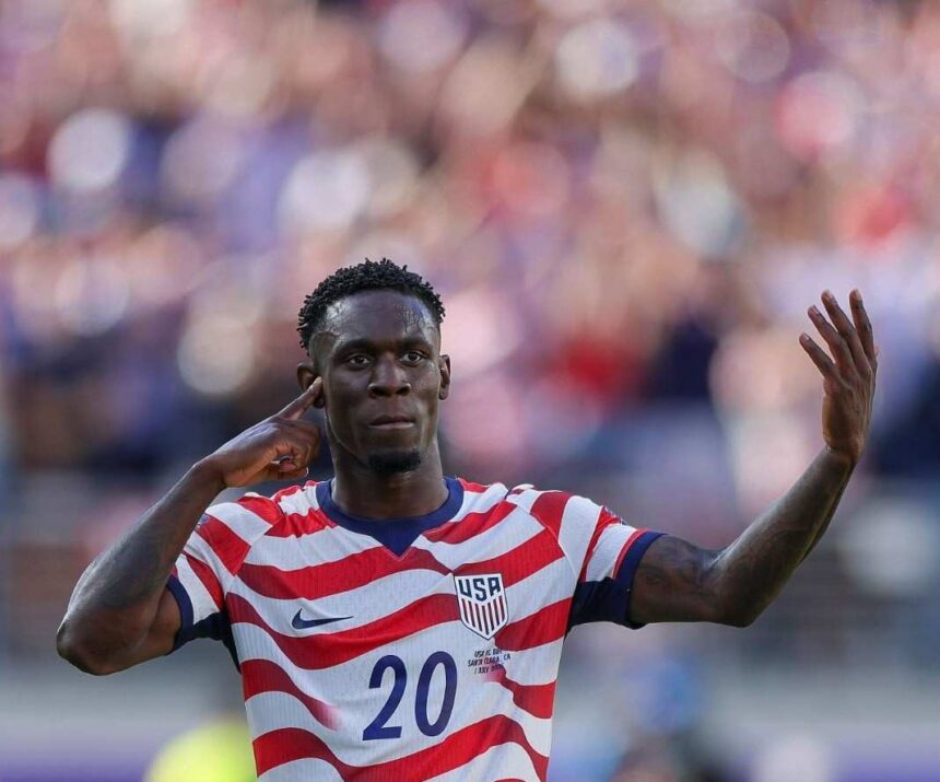 USA forward Folarin Balogun wearing the 20 red and white striped home kit celebrates with his finger to his ear and one arm raised after scoring his teams first goal during the FIFA World Cup 2026 Round of 32 match against Bosnia and Herzegovina at San Francisco Bay Area Stadium in Santa Clara California on July 1 2026  trybalnews