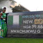 Gold medalist Goodness Nwachukwu of Team Nigeria in green and white kit stands next to a Longines scoreboard at Scotstoun Stadium holding a Nigerian flag and crutches after setting a new world record of 3966m in the Womens Discus Throw F42 44F61 64 Final on Day 6 of the Glasgow 2026 Commonwealth Games July 29 2026  trybalnews