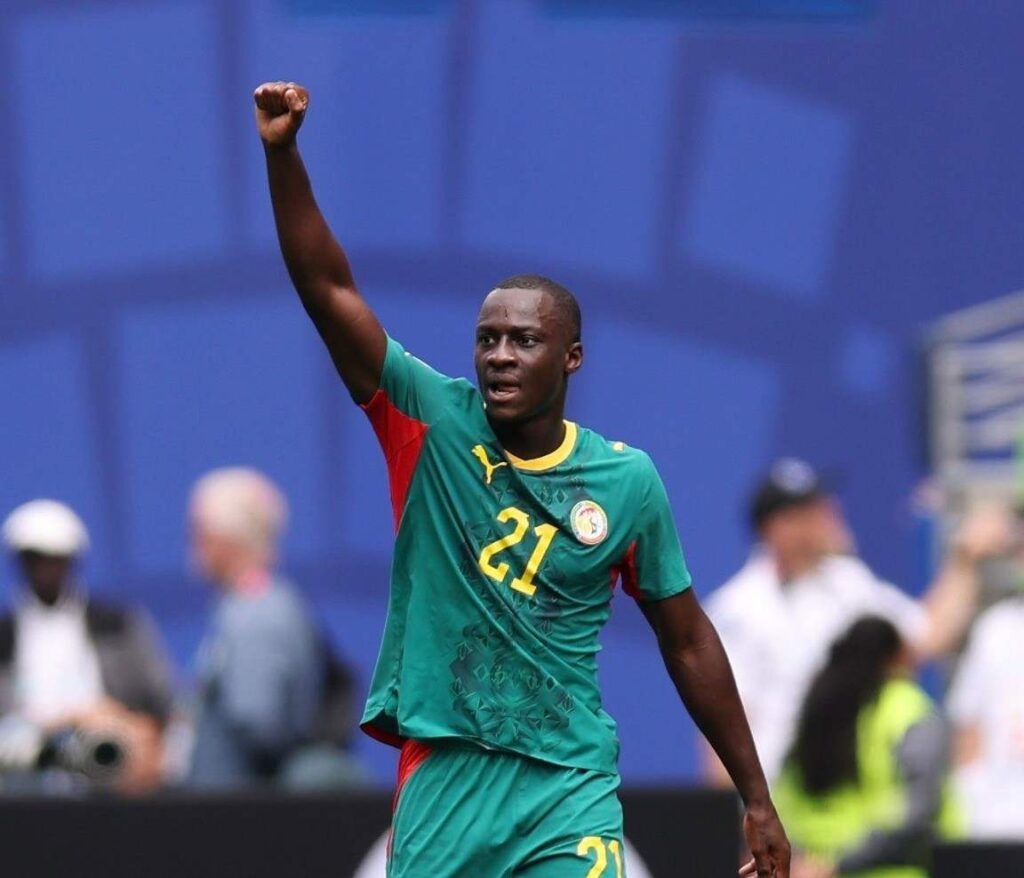 Senegal midfielder Habib Diarra wearing the 21 green home kit with yellow numbers celebrates with a raised right fist after scoring his teamaposs first goal during the FIFA World Cup 2026 Round of 32 match against Belgium at Seattle Stadium in Seattle Washington on July 1 2026  trybalnews