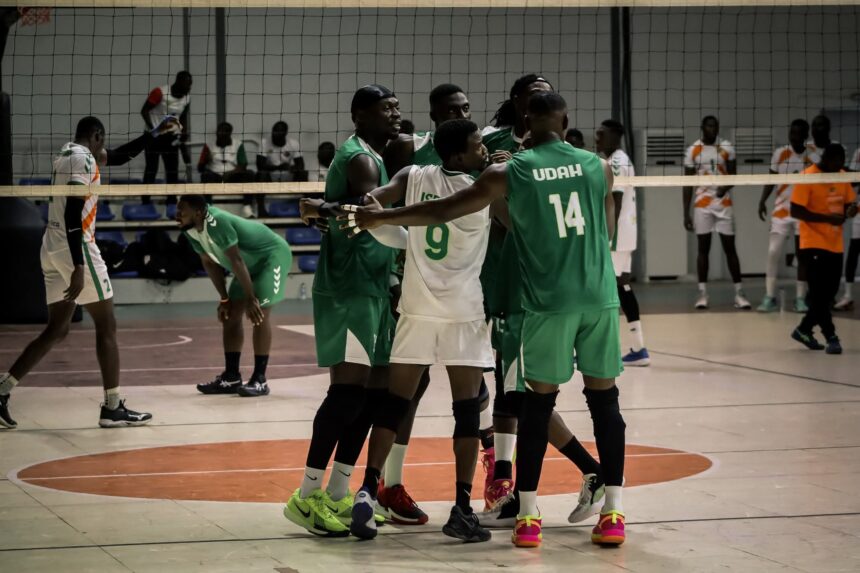 Indoor team sport scene with players in green and white uniforms gathering in a huddle near the net celebrating or encouraging each other on a court  trybalnews