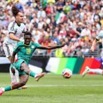 Senegal forward Ismaila Sarr wearing the 18 green kit strikes the ball with his right foot to score his teams second goal while being challenged by two Belgium defenders in light blue and pink away kits during the FIFA World Cup 2026 Round of 32 match at Seattle Stadium in Seattle Washington on July 1 2026  trybalnews