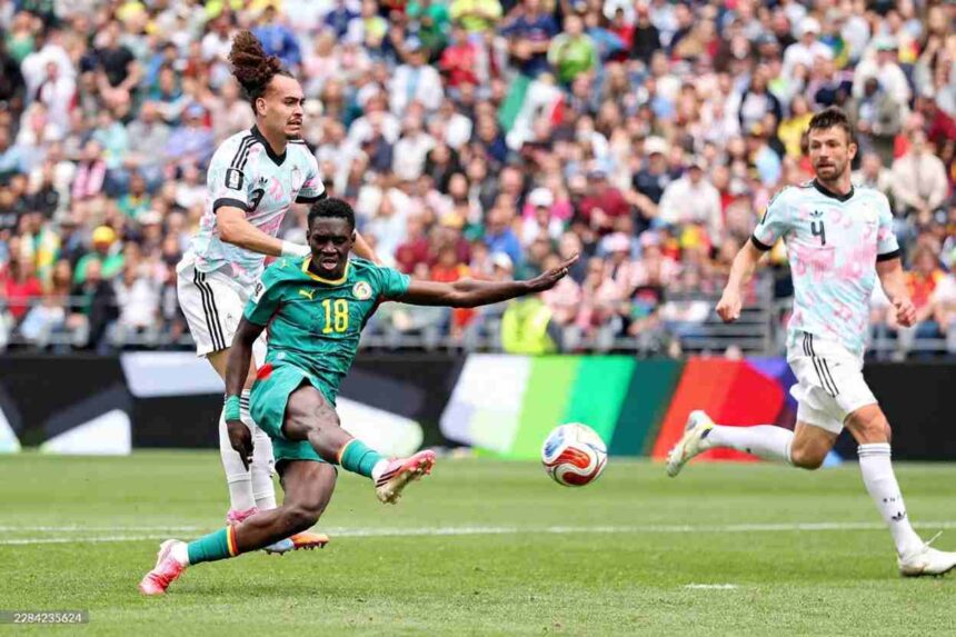 Senegal forward Ismaila Sarr wearing the 18 green kit strikes the ball with his right foot to score his teams second goal while being challenged by two Belgium defenders in light blue and pink away kits during the FIFA World Cup 2026 Round of 32 match at Seattle Stadium in Seattle Washington on July 1 2026  trybalnews