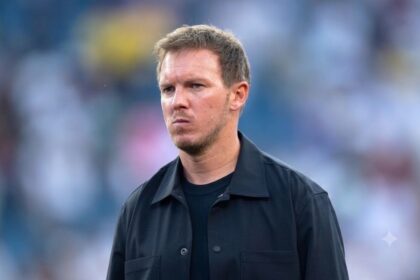 Julian Nagelsmann, head coach of Germany, stands on the sideline with a serious expression during the FIFA World Cup 2026 Round of 32 match between Germany and Paraguay at Boston Stadium in Foxborough, Massachusetts, on June 29, 2026. He is wearing a black collared jacket over a black crew neck shirt, looking to his left. The background is a blurred stadium crowd. (Photo by Joe Prior/Visionhaus via Getty Images)