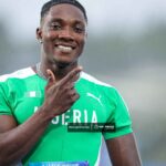 Smiling male athlete in a green Nigeria jersey giving a thumbs up in the rain outdoors  trybalnews