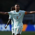 France forward Kylian Mbappe wearing a light blue 10 jersey and orange captains armband celebrates with arms outstretched after scoring Frances first goal in the FIFA World Cup 2026 Quarter Final match against Morocco at Boston Stadium in Foxborough Massachusetts on July 9 2026  trybalnews