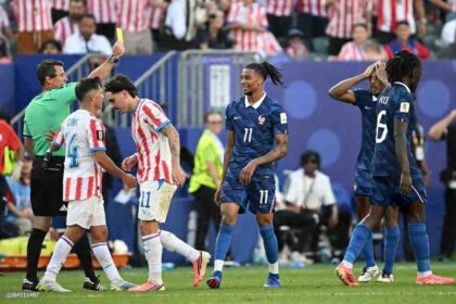Uzbek referee Ilgiz Tantashev shows a yellow card to France forward Michael Olise #11 during the 2026 World Cup round of 16 match between Paraguay and France at Lincoln Financial Field in Philadelphia on July 4, 2026.