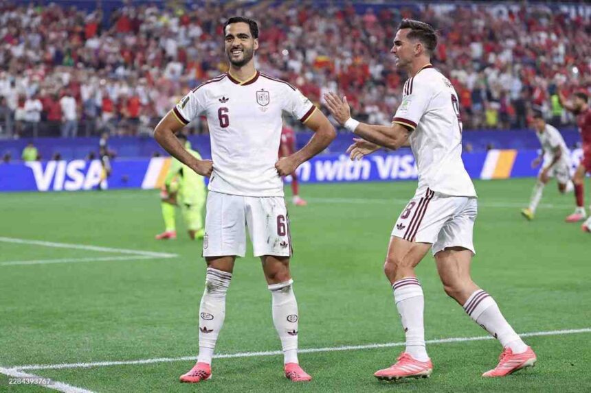 Spain midfielder Mikel Merino 6 smiles with hands on hips as he celebrates his teams first goal during the 2026 World Cup round of 16 match between Portugal and Spain at Dallas Stadium in Arlington on July 6 2026 A Spain teammate in jersey 8 approaches to congratulate him  trybalnews