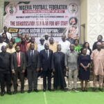 Group of men and women in formal and traditional attire pose on steps in front of a Nigeria Football Federation banner at an anti corruption seminar event  trybalnews