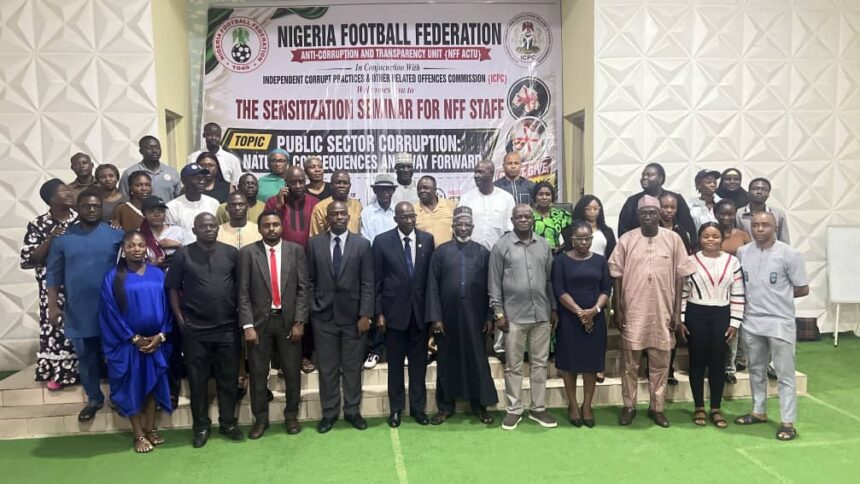 Group of men and women in formal and traditional attire pose on steps in front of a Nigeria Football Federation banner at an anti corruption seminar event  trybalnews
