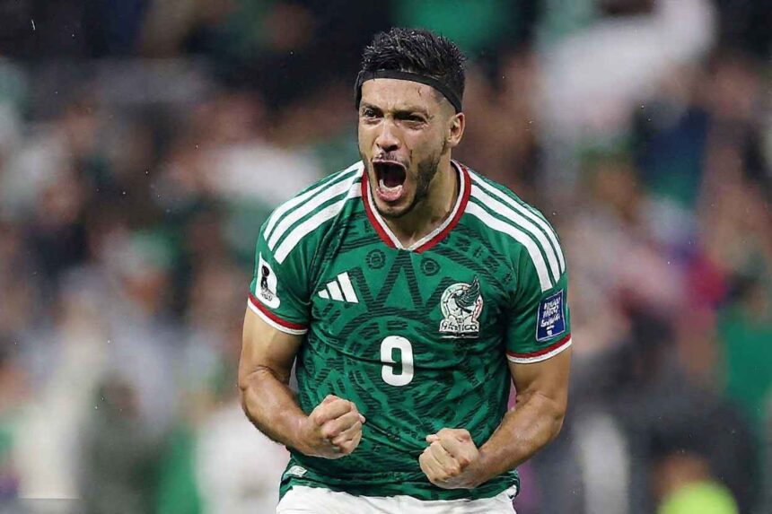 Mexico striker Raul Jimenez wearing a green 9 jersey with white Adidas stripes white shorts and a black headband celebrates with a fierce expression He roars with his mouth open and both fists clenched in front of his chest after scoring Mexicos second goal His Mexico crest and World Cup 2026 sleeve patches are visible The background shows a blurred stadium crowd in green and white This is during the FIFA World Cup 2026 Round of 32 match between Mexico and Ecuador on June 30 2026 at Mexico City Stadium Mexico City Mexico  trybalnews