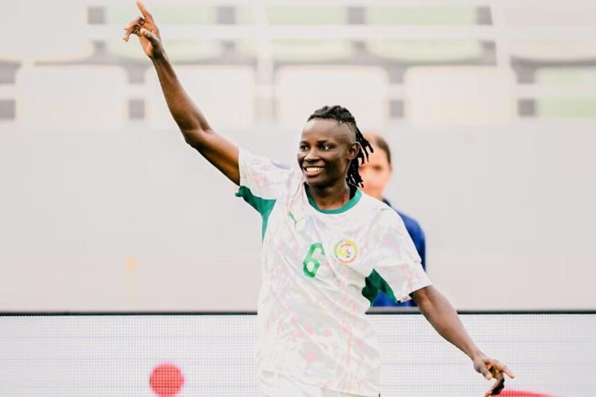 Soccer player in white and green jersey with number 6 celebrating right arm raised in the air on the field  trybalnews