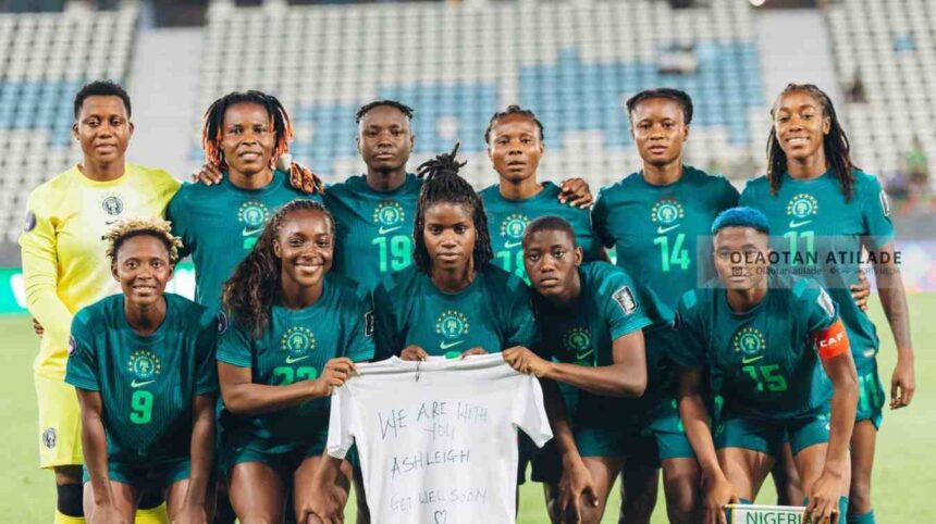 Nigerian womens soccer team in teal uniforms posing for a group photo on the field holding a white shirt with a get well message   trybalnews