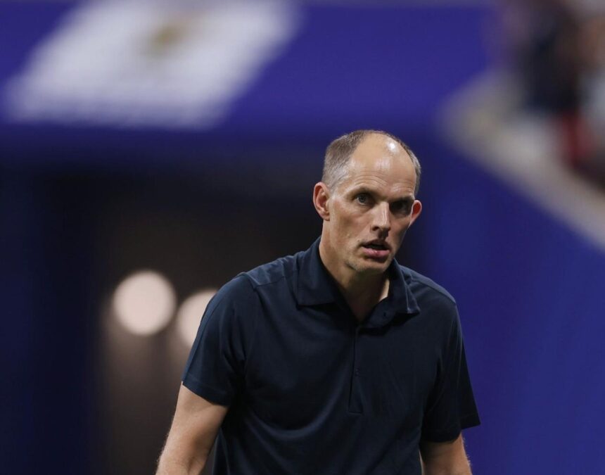 Man in a dark polo on a tennis court looking focused against a blue background  trybalnews
