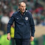 England head coach Thomas Tuchel stands on the touchline wearing a navy blue England training jacket with the Three Lions crest He looks focused during the FIFA World Cup Round of 16 match at Mexico City Stadium on Sunday July 5 2026 Stadium crowd and green seating are blurred in the background  trybalnews