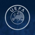 UEFA logo circular emblem with a striped globe and the letters UEFA arched on a dark blue background  trybalnews