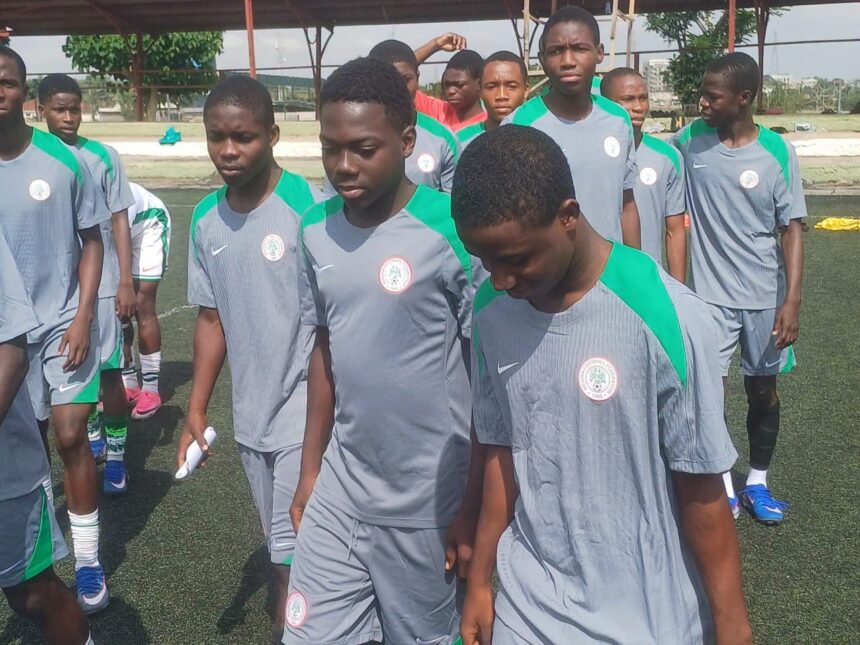 A group of young male soccer players in gray and green jerseys standing in a line on a turf field  trybalnews
