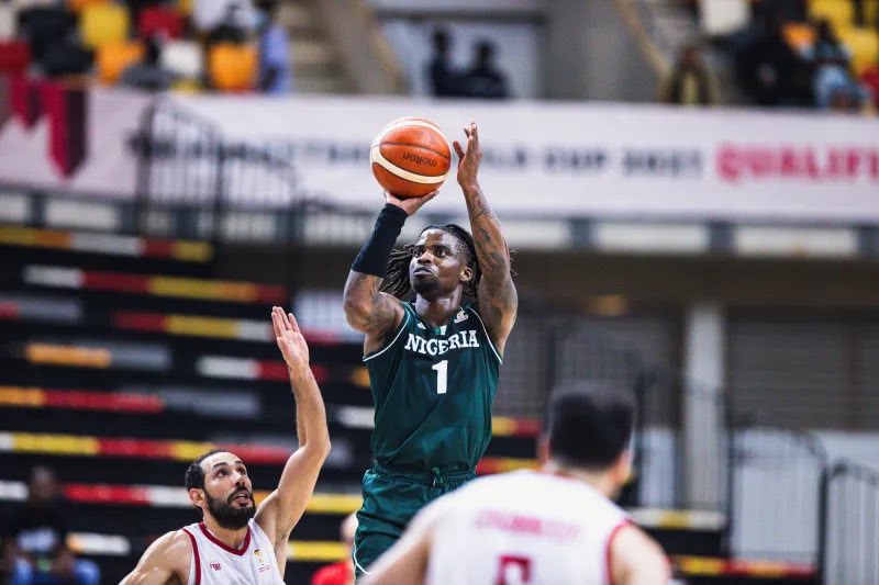 WhatsApp Image 20260702 at 155311 Trybal News Nigerian basketball player in green jersey number 1 leaps for a jump shot as a defender reaches up much closer to the ball in the foreground trybalnews