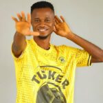 Smiling man in a bright yellow sports jersey cupping his hand to his ear as if listening intentively  trybalnews