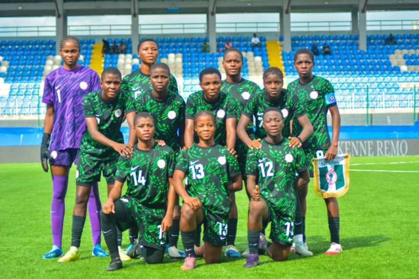 Womens soccer team in green and black jerseys posing for a group photo on a stadium field goalkeeper in purple on the left  trybalnews