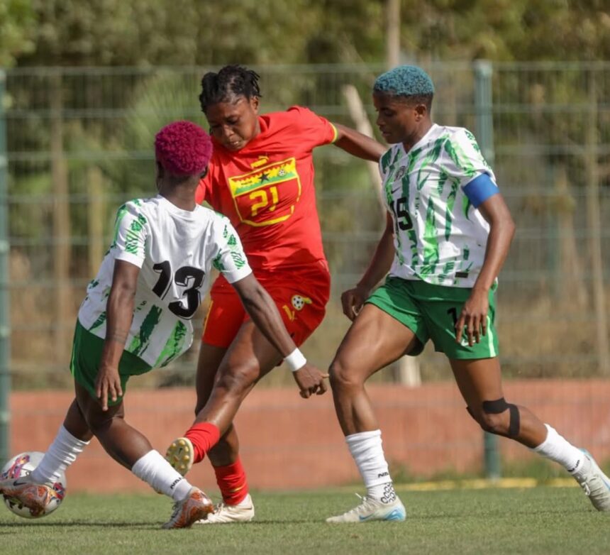 Three soccer players compete for the ball during a match a player in red is between two in white and green kits  trybalnews
