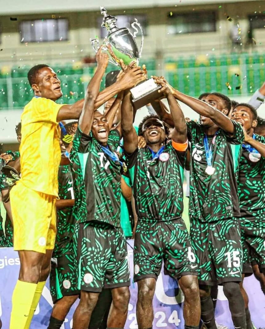 Soccer team in green and black celebrate holding a large silver trophy aloft confetti flying  trybalnews