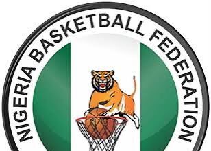 Nigeria Basketball Federation (NBBF) logo with a tiger dunking a basketball inside a hoop and green-white-green colors around the edge.