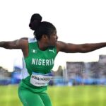 Female Nigerian track and field athlete in a green uniform throwing discus with arms extended mid throw on a field  trybalnews