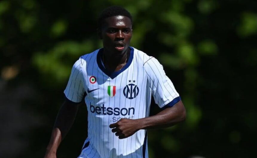 Soccer player in a white pinstripe jersey with blue trim sprinting on a sunny field  trybalnews