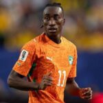 Soccer player in orange jersey with number 11 running on the field during a match  trybalnews