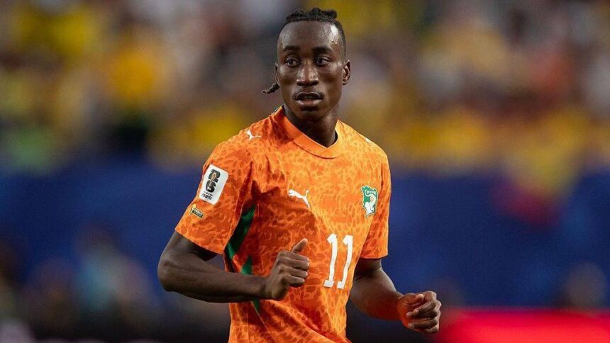 Soccer player in orange jersey with number 11 running on the field during a match  trybalnews