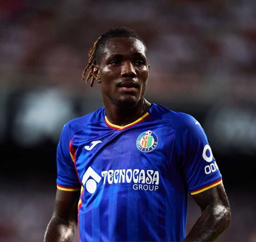 Close up shot of Getafe CF footballer Chrisantus Uche looking ahead on the pitch while wearing a blue home kit during a LaLiga match  trybalnews