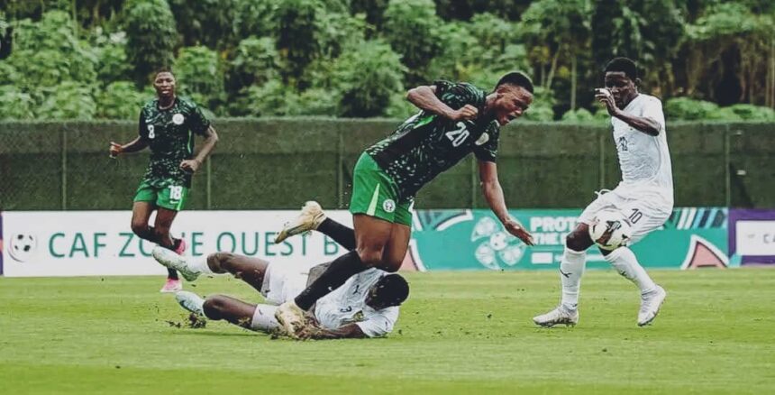 Soccer players in green and white chase the ball on a grass field one player tumbles as others move toward the ball  trybalnews