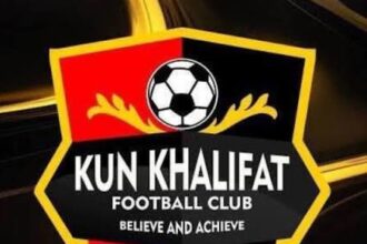 Logo for Kun Khalifat Football Club: a shield with red and black halves, a soccer ball at the top, gold accents, and the motto 'Believe and Achieve'.