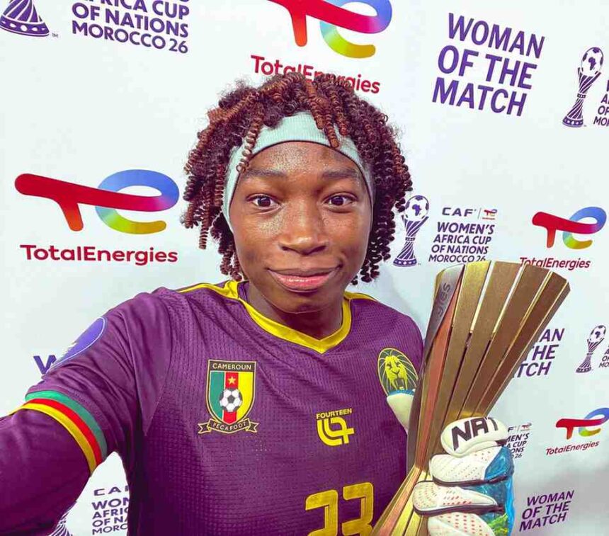 Female Cameroon footballer selfies after a win wearing a purple jersey and headband holding a tall gold trophy  trybalnews