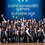 Gold medalists of Team New Zealand celebrate during the Netball medal ceremony on Day 10 of the Glasgow 2026 Commonwealth Games at The Hydro August 2 2026 Players and coaches in black and white tracksuits pose together on stage holding up gold medals and Commonwealth Games mascots with a Commonwealth Games GLASGOW 2026 backdrop behind them  trybalnews