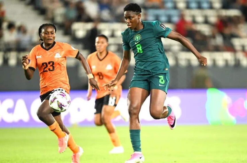 Two female soccer players chase the ball during a match green Nigeria kit 8 vs orange kit 23  trybalnews