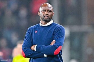 Former Genoa head coach Patrick Vieira stands with arms crossed on the sideline wearing a navy blue sweater with red elbow patches during the Serie A match between Genoa CFC and US Cremonese at Luigi Ferraris Stadium.