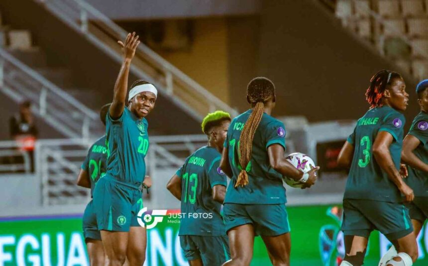 Nigerias Super Falcons player Monday Gift wearing jersey number 20 and a white headband raises her hand and celebrates with teammates after scoring the teams second goal during a WAFCON Group C match against Egypt Other Nigerian players in teal and green kits are running and celebrating on the pitch in a stadium  trybalnews