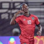 Soccer player in a red jersey with the number 10 celebrating a goal on the pitch  trybalnews
