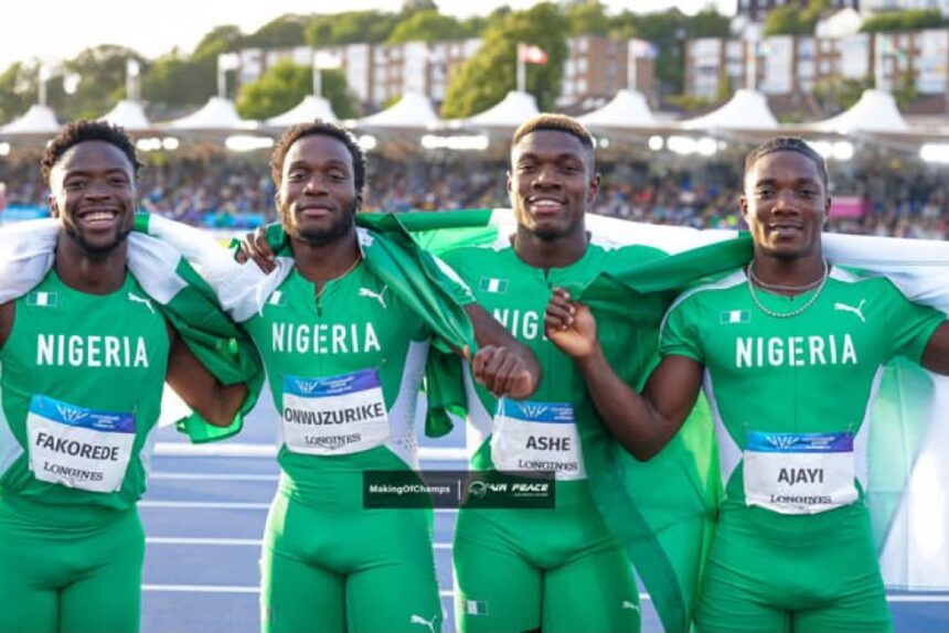 Four Nigerian male sprinters in green Nigeria jerseys pose with arms around each other after a race smiling on a track with crowd in the background  trybalnews