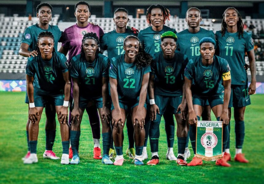 Nigeria womens national football team group photo on the pitch in teal kits with a Nigeria banner visible in front  trybalnews