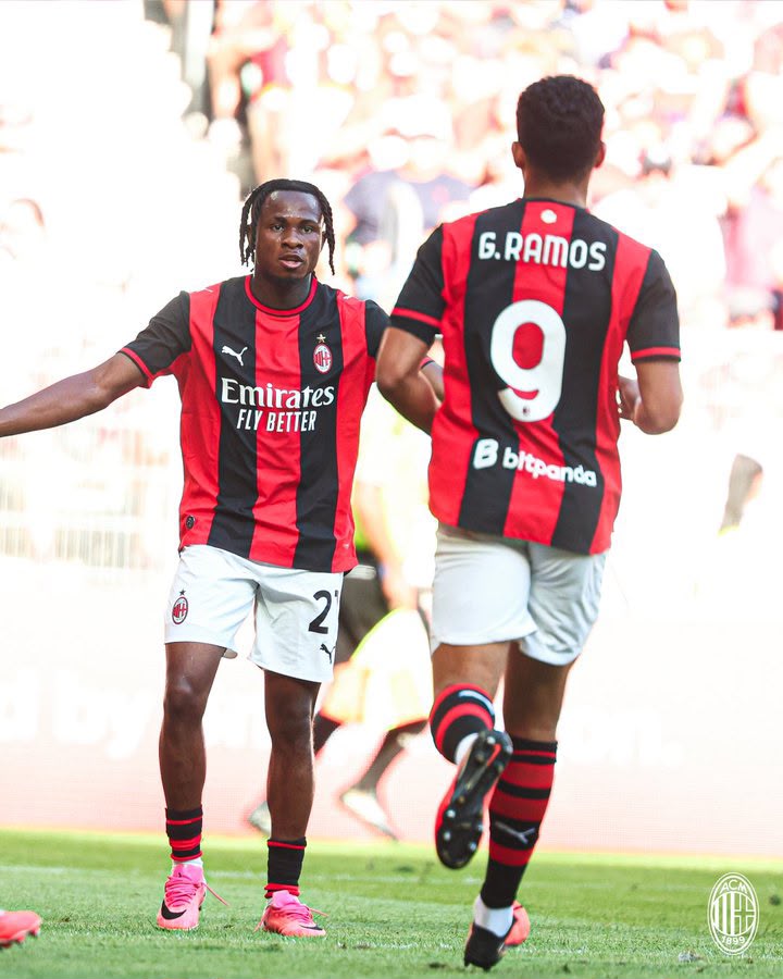 Samuel Chukwueze Trybal News AC Milan players celebrate on the pitch in red and black striped kits left player with number 2 on shorts right player shows back with G Ramos and number 9 trybalnews