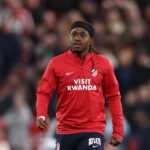 Ademola Lookman of Atletico de Madrid wearing a red and white striped jersey and blue shorts warms up during half time on the pitch at Anfield during the UEFA Champions League 202627 League Phase match between Liverpool FC and Atletico de Madrid on September 9 2026 in Liverpool England  trybalnews