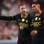 Chelseas Jordan Henderson left gestures and shouts while directing play alongside teammate Maxence Lacroix Both players wear Chelseas black away kit with yellow USDC by Circle sponsorship during the Premier League match at the Gtech Community Stadium in Brentford on September 18 2026  trybalnews